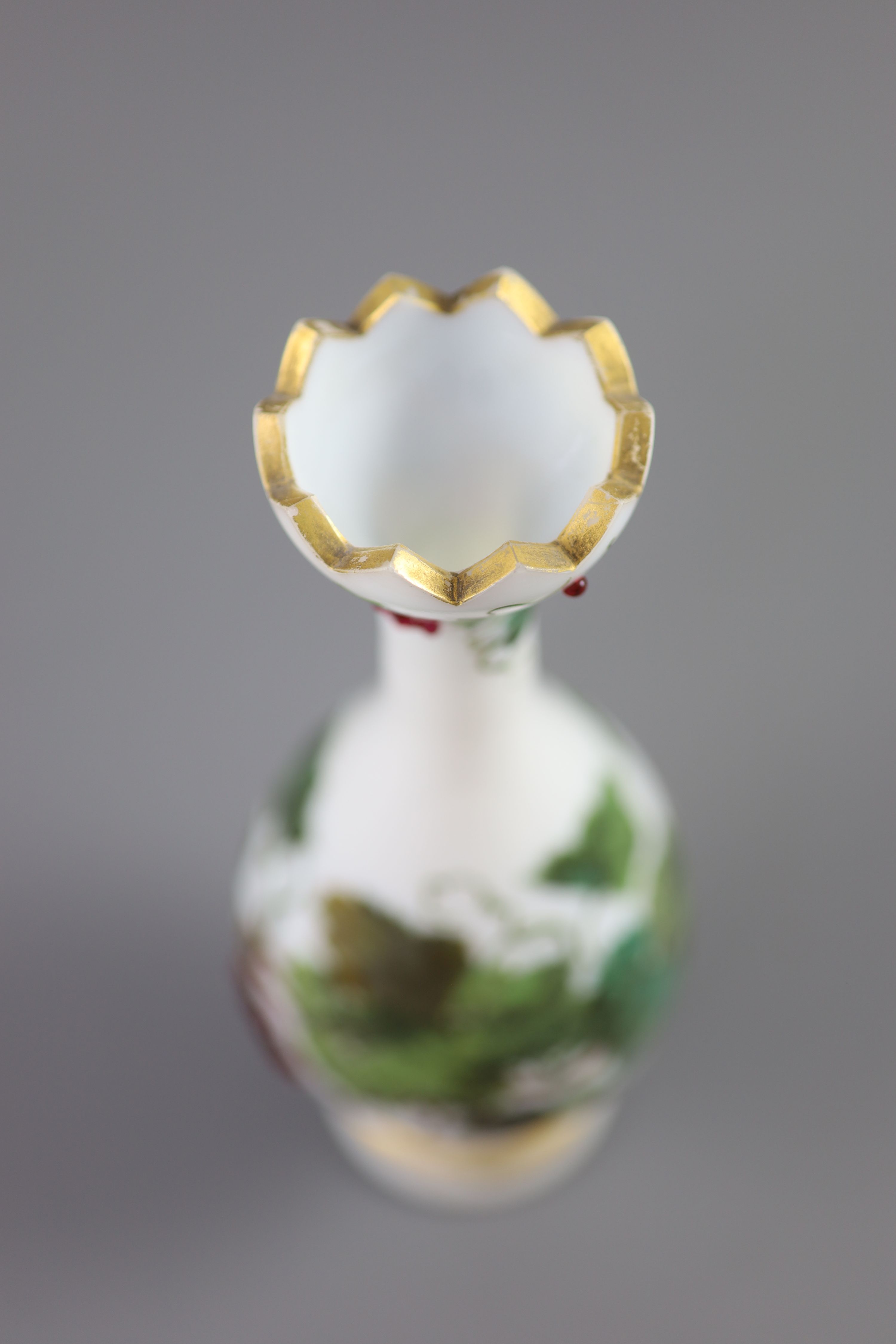 A French opaline glass vase with applied grapes and a pair of Webb style ruby and white glass vases, tallest 26cm